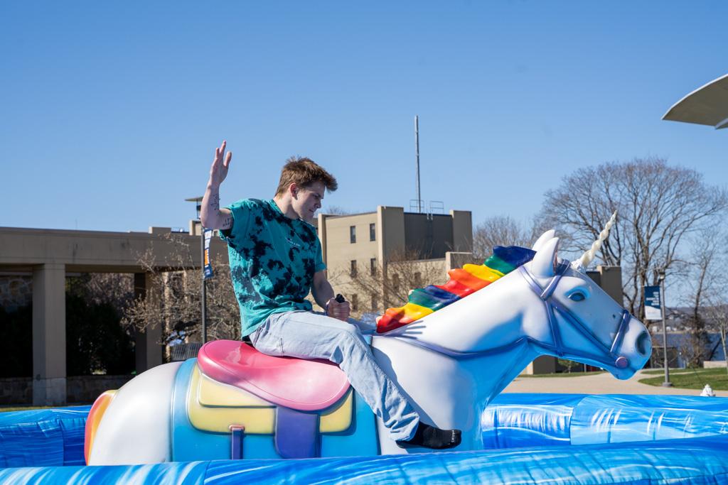 Student rides a mechanical unicorn